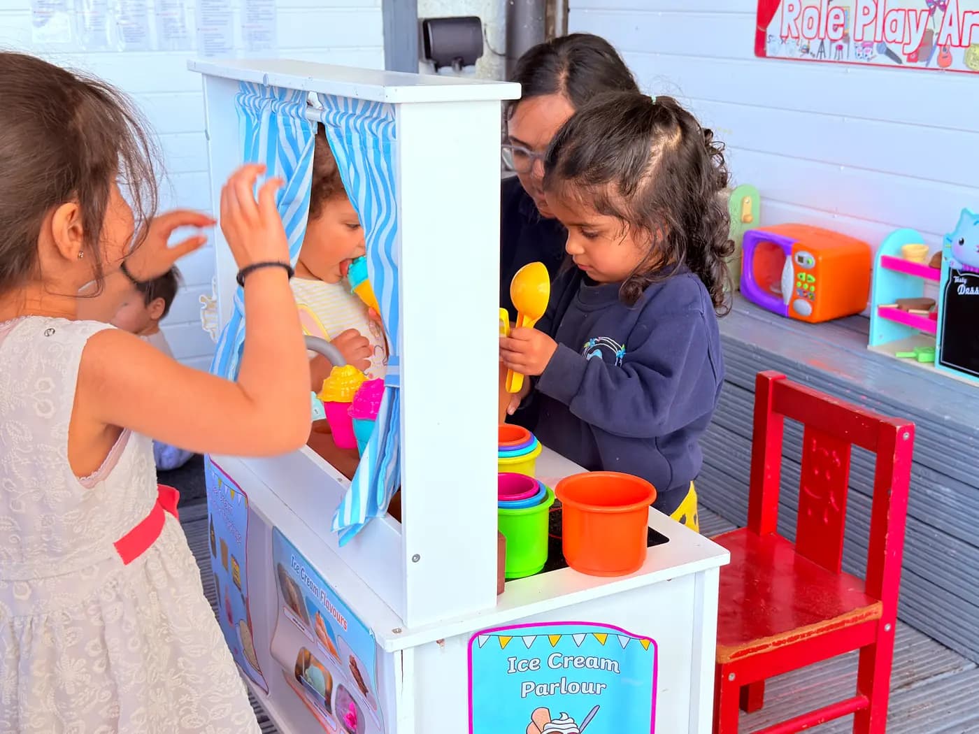 Children at the ice-cream parlour role-play area at Blue Nest Montessori Harrow