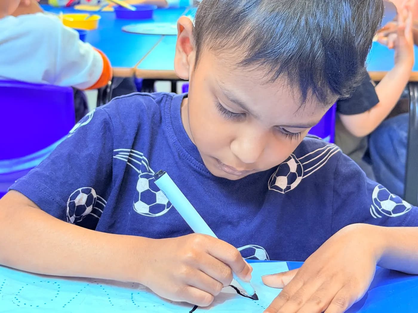 Child practising early pre-writing and mark-making at Blue Nest Montessori Harrow